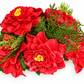 Poinsettia wax melt centerpiece with red blooms and evergreen sprigs, angled view