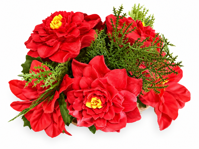 Poinsettia wax melt centerpiece with red blooms and evergreen sprigs, angled view