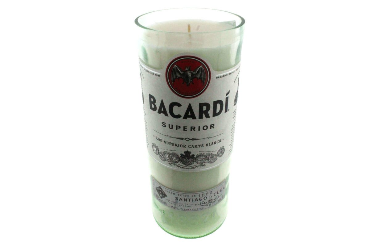 The Recycled White Rum Candle is a natural soy candle in a glass container crafted from a recycled white rum bottle, featuring the original Bacardi Superior label.