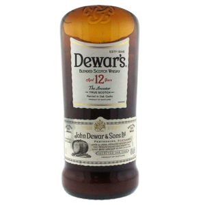 A Recycled Blended Scotch Whiskey Candle - Curved Cut, crafted from a Dewar's 12 Year Old bottle with a white and gold label—ideal for upcycled decor or as a unique whiskey bottle candle.