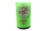 The Recycled Ginger Ale Soda Candle is a green soy candle poured into a recycled Canada Dry ginger ale bottle labeled “Ginger Ale Soda Gingembre, 355 mL, 100% Natural Flavour,” blending nostalgia with eco-friendly appeal.