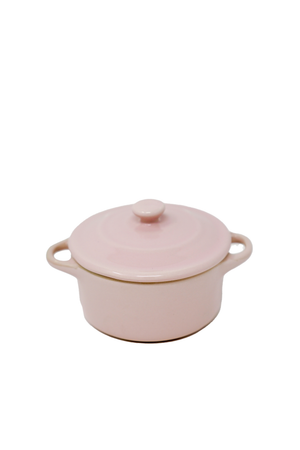 The Pink Mini Cereal Crockpot Candle features a pink ceramic dish with a matching lid and side handles, displayed on a white background—ideal as an eco-friendly candle for your favorite spaces.