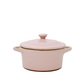 The Pink Mini Cereal Crockpot Candle, shaped like a pink ceramic casserole dish with handles and a lid, is shown against a plain white background.