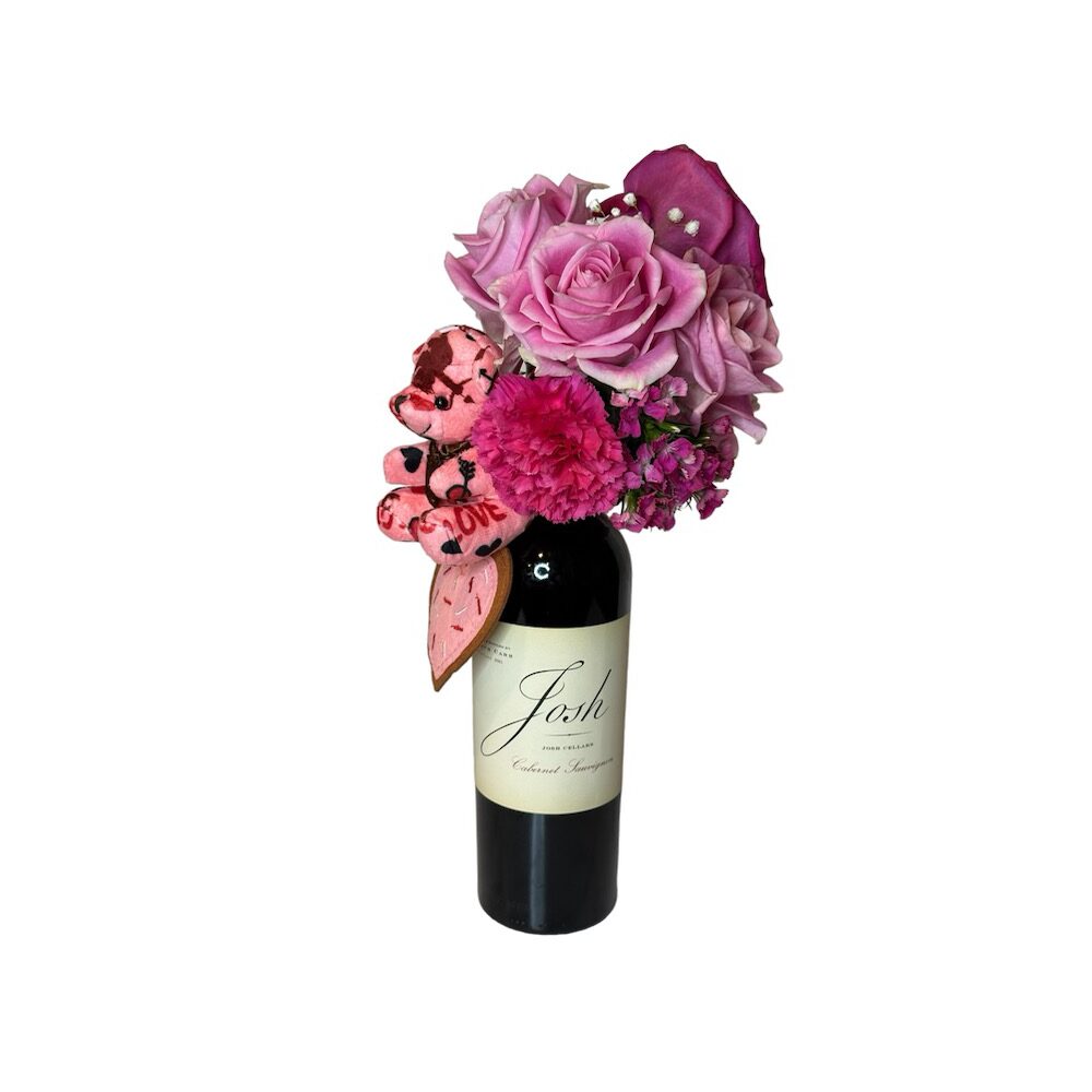 The Wine and Flowers set pairs a bottle of Josh Cabernet Sauvignon with pink and purple Valentine’s Day blooms and heart-shaped decorations—perfect for a romantic gift.