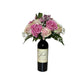 Wine and Flowers features a bottle creatively repurposed as a vase, holding pink roses, white blooms, and lush greenery—a romantic gift idea perfect for displaying Valentine’s Day flowers.