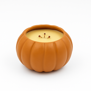 The Large Orange Ceramic Pumpkin Candle features a reusable ceramic holder and a yellow natural soy candle with three wicks, perfect for adding charm to your seasonal décor. Set against a plain white background.