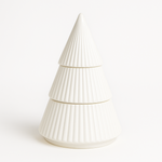 The White Ceramic Christmas Tree Candle is a ribbed, tiered ceramic candle shaped like a festive tree, crafted with all-natural wax and displayed against a plain white background.