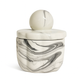 The Marble Luxe Candle is a small, round ceramic container with a marbled black and white design, featuring a matching lid topped with a spherical handle for added elegance.