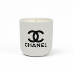 The White Ceramic Designer Candle showcases the black Chanel logo and brand name on a white ceramic container, making it an ideal designer piece for elegant interiors.