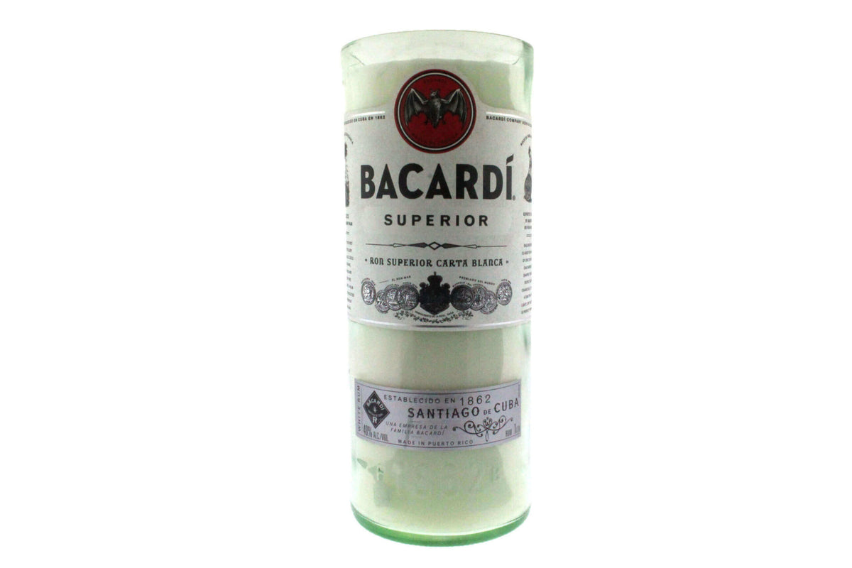 The Recycled White Rum Candle, crafted from a Bacardi Superior rum bottle and featuring its original label, adds unique style to your space as an eco-friendly, repurposed glass candle.
