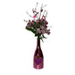 Valentine Bouquets: Pink flowers and decorative branches in a repurposed bottle vase labeled "XOXO"—a charming, eco-friendly arrangement perfect for Valentine’s Day.