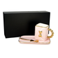 The 3D Design Handbag Shaped Ceramic Coffee Cups Set features a pink and gold cup with a decorative handle, matching rectangular tray, gold spoon, and comes in a black box—an elegant and practical decorative gift.