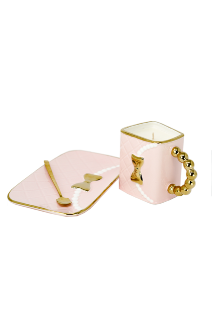 The 3D Design Handbag Shaped Ceramic Coffee Cups Set includes a pink candle in a square holder with gold accents, matching rectangular tray, and gold spoon—making it an ideal decorative and practical gift for any stylish space.