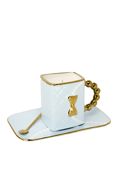 The 3D Design Handbag Shaped Ceramic Coffee Cups Set features a light blue, square cup with a gold handle, bow detail, matching rectangular saucer, and gold-edged spoon—a practical and decorative gift for any occasion.