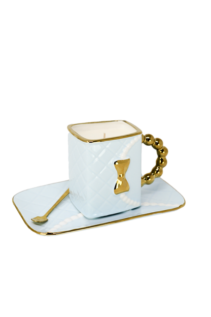 The 3D Design Handbag Shaped Ceramic Coffee Cups Set features a light blue, square cup with a gold handle, bow detail, matching rectangular saucer, and gold-edged spoon—a practical and decorative gift for any occasion.