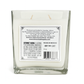 The Recycled Silver Tequila Candle features a square glass design, white soy wax with two wicks, and a side label with manufacturer info, website, barcode, and government warning. This candle adds a unique touch to any setting.