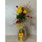 Valentine Bouquets: Yellow roses with red accents arranged eco-friendly in a clear, repurposed bottle vase, topped with a yellow heart tag marked "SWEET.
