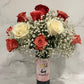 Wine and Flowers: A romantic bouquet of red, white, and pink roses with baby's breath in a glass vase labeled "Rosé the day away"—the perfect Valentine’s Day gift or centerpiece against a light marble backdrop.