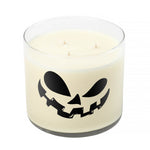 The 3 Wick Clear Tumbler Halloween Candle with Scary Pumpkin (Face #2) is a white soy wax candle in a clear jar, featuring a black jack-o'-lantern face design for a clean, long-lasting burn.