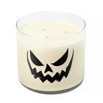 The 3 Wick Clear Tumbler Halloween Candle with Scary Pumpkin (Face #5) is a white soy wax candle in a clear glass jar, decorated with a black jack-o'-lantern face on the front.