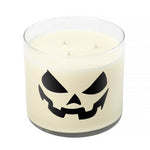 The 3 Wick Clear Tumbler Halloween Candle with Scary Pumpkin (Face #3) features a white candle in a clear glass holder, adorned with a black jack-o'-lantern face—ideal as festive pumpkin décor.