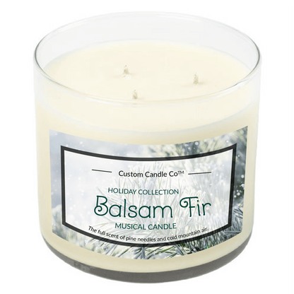 The Musical Holiday Candle – Balsam Fir is a white three-wick candle in a clear glass jar from Custom Candle Co's Holiday Collection, offering a festive balsam fir scent paired with charming musical features.