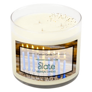The Musical Holiday Candle – Slate Hanukkah is a white three-wick natural soy candle in a glass jar with a menorah label, ideal for Hanukkah or as part of our Musical Holiday Candles collection.