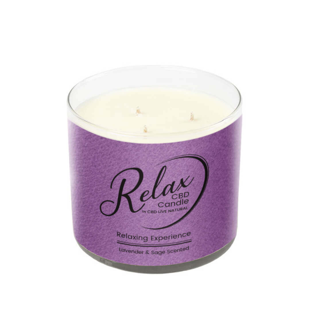 The RELAX Aromatherapy Candle 16oz – Purple Tumbler is a CBD-infused soy wax candle with lavender and sage fragrance, in a clear glass holder and a purple label, creating a soothing, calming ambiance.