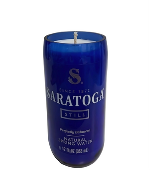 The Recycled Still Spring Water Bottle Candle features a blue repurposed bottle with an eco-friendly soy candle, visible wick, and white wax inside.