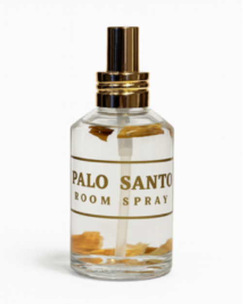 Clear glass bottle labeled "Palo Santo Box Set" with gold details and visible wood pieces inside, set against a white background.