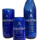 Three blue Saratoga Still water bottles, two made into cups and one as a Recycled Still Spring Water Bottle Candle, are displayed upright on a white background.