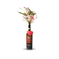 The Valentine Bouquets feature pink and white flowers in a repurposed bottle vase, accented with a heart-shaped cookie—an eco-friendly and sustainable Valentine’s Day gift.