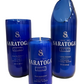 One "Recycled Still Spring Water Bottle Candle" and two blue glass containers shaped as drinking glasses, all originally labeled "Saratoga Still Natural Spring Water.