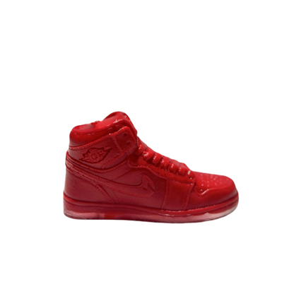 The AJ-1 Red Hightop Sneaker Candle – Small (On Backorder) is a hand-poured candle shaped like a red high-top sneaker, displayed against a plain white background to highlight its distinctive design.
