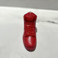 The AJ-1 Red Hightop Sneaker Candle – Large (On Backorder) is a hand-poured candle shaped like a red high-top sneaker, infused with Black Ice fragrance and displayed on a white surface.