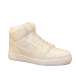 The AJ-1 White Hightop Sneaker Candle – Large (currently on backorder) is a hand-poured, all-wax candle modeled after a classic white high-top sneaker, shown against a simple light background.