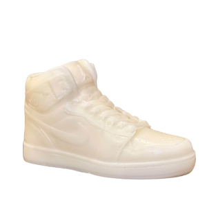 The AJ-1 White Hightop Sneaker Candle – Large (currently on backorder) is a hand-poured, all-wax candle modeled after a classic white high-top sneaker, shown against a simple light background.