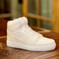 The AJ-1 White Hightop Sneaker Candle – Large, shaped like a detailed high-top athletic shoe, sits on a wooden surface and features the fresh Black Ice fragrance for a stylish touch. Now on backorder.