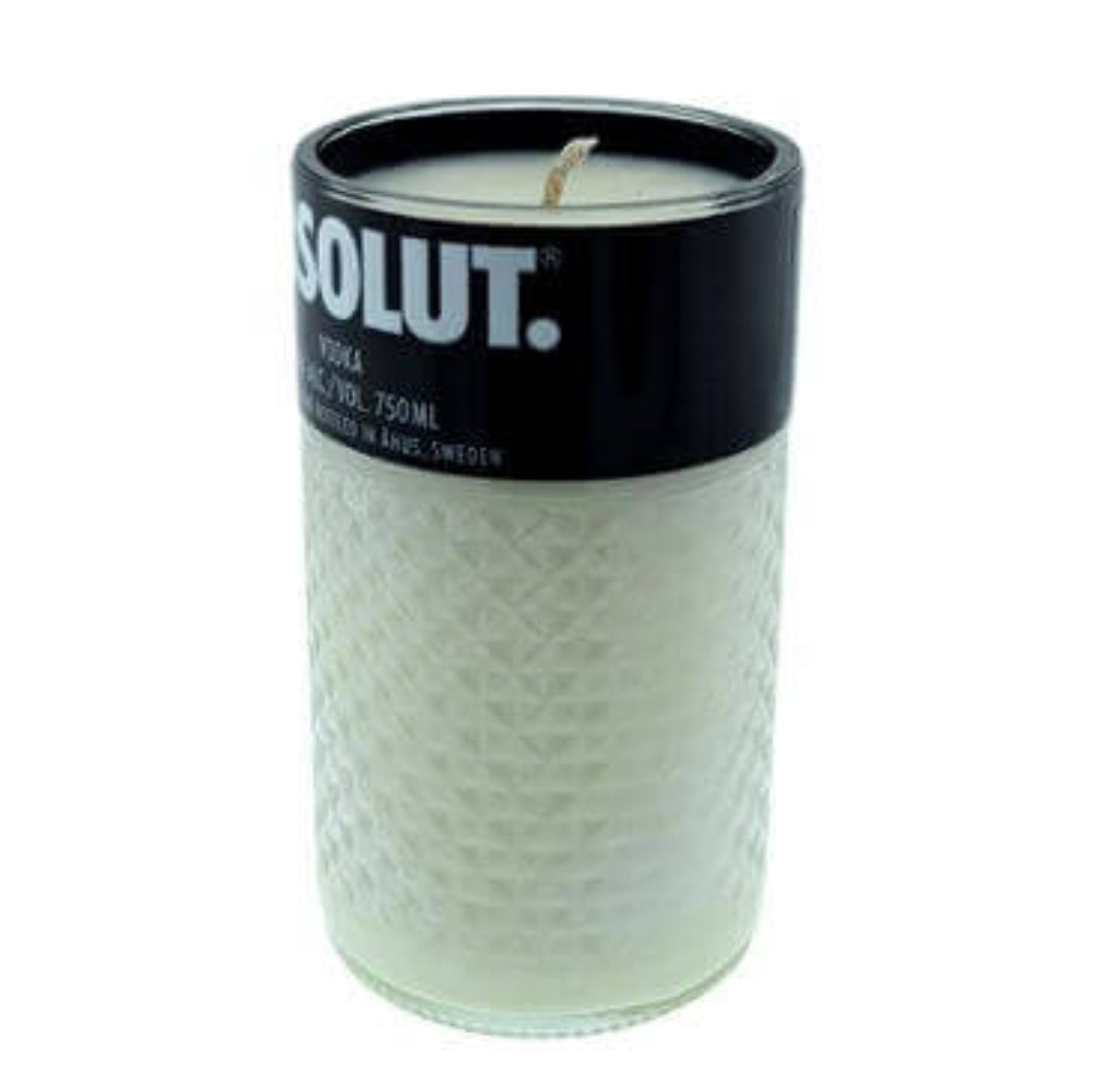 The Recycled Black Label Vodka Candle is a white natural soy candle in a textured glass container with a black lid, inspired by vodka bottle caps and labeled "SOLUT," offering a unique recycled touch.