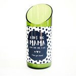 A green glass candle made from a recycled wine bottle with a slanted top and a label that says, “Ain't no mama like the one I got. I love you mom!” shown against a white background.