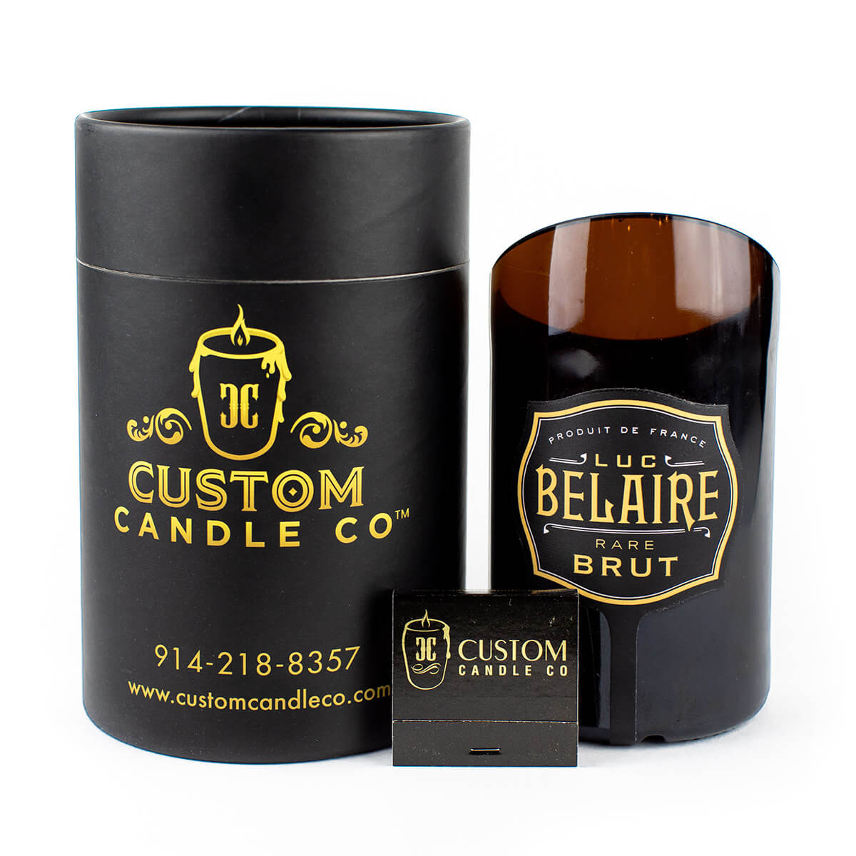 The Recycled Black Champagne Candle, labeled "Luc Belaire Rare Brut," is shown with Black Custom Candle Co. packaging and a branded matchbox, all displayed against a white background.