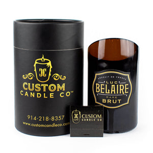 The Recycled Black Champagne Candle, labeled "Luc Belaire Rare Brut," is shown with Black Custom Candle Co. packaging and a branded matchbox, all displayed against a white background.