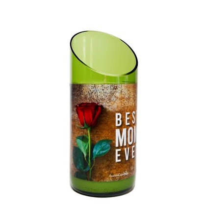 A green glass vase with a slanted rim features a red rose and “BEST MOM EVER” text—perfect to pair with the “Best Mom Ever” Quote Candle.