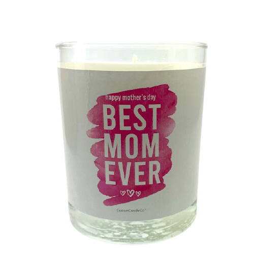 A clear glass "Best Mom Ever" candle in a pink design with white and pink "happy mother's day BEST MOM EVER" label, heart icons, lavender violet-scented soy wax inside, packaged in a brown box.
