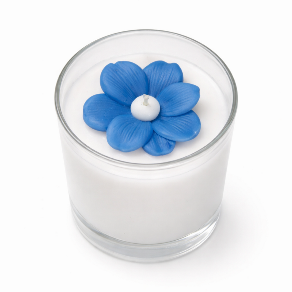 The Blue Blossom Candle is a handcrafted white soy candle in a glass holder, adorned with a decorative blue flower on top.