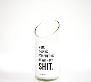 The Thanks for Puttin’ Up with My Shit soy candle, poured into a recycled wine bottle and featuring a white label, is displayed against a plain white background.