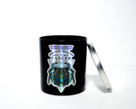The Zodiac: Cancer Candle is a black soy jar with a silver lid, featuring a holographic crab, crystal, zodiac dates, and "Zodiac Candles" on the front—an ideal gift for anyone with the Cancer zodiac sign.
