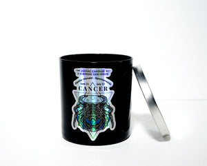 The Zodiac: Cancer Candle is a black soy jar with a silver lid, featuring a holographic crab, crystal, zodiac dates, and "Zodiac Candles" on the front—an ideal gift for anyone with the Cancer zodiac sign.
