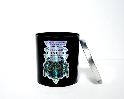 The Zodiac: Cancer Candle is a black soy jar with a silver lid, featuring a holographic crab, crystal, zodiac dates, and "Zodiac Candles" on the front—an ideal gift for anyone with the Cancer zodiac sign.