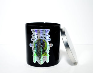 The Zodiac: Virgo Candle is a black soy candle labeled "Virgo," featuring a woman illustration and astrological details. Shown with the silver lid off, this natural soy candle offers a clean, long-lasting burn.